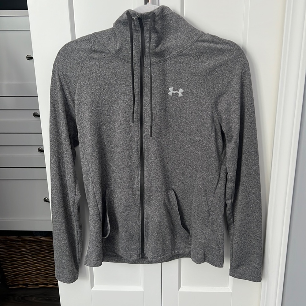 Woman’s dark gray under Armour zip up